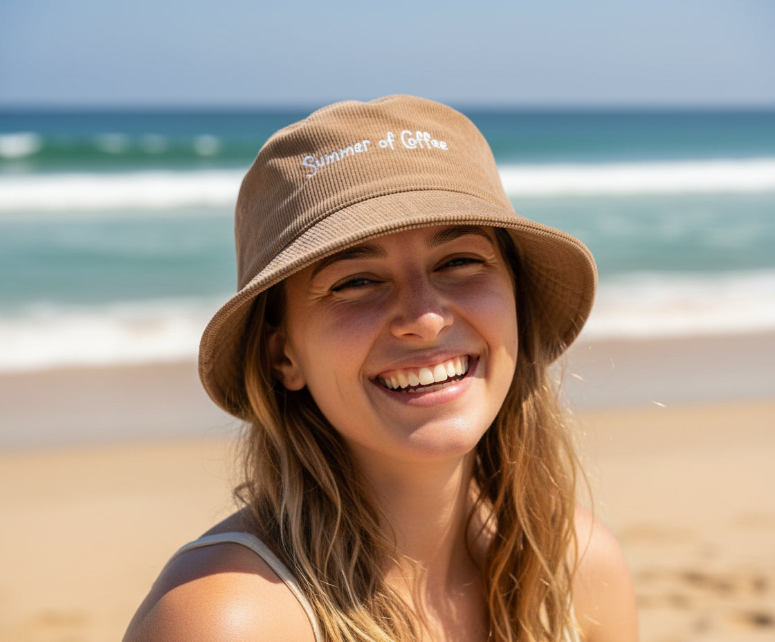 Beige bucket hat with 'Summer of Coffee' text on a white background