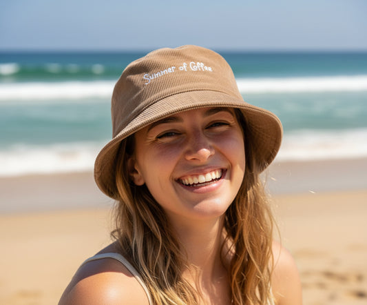 Beige bucket hat with 'Summer of Coffee' text on a white background