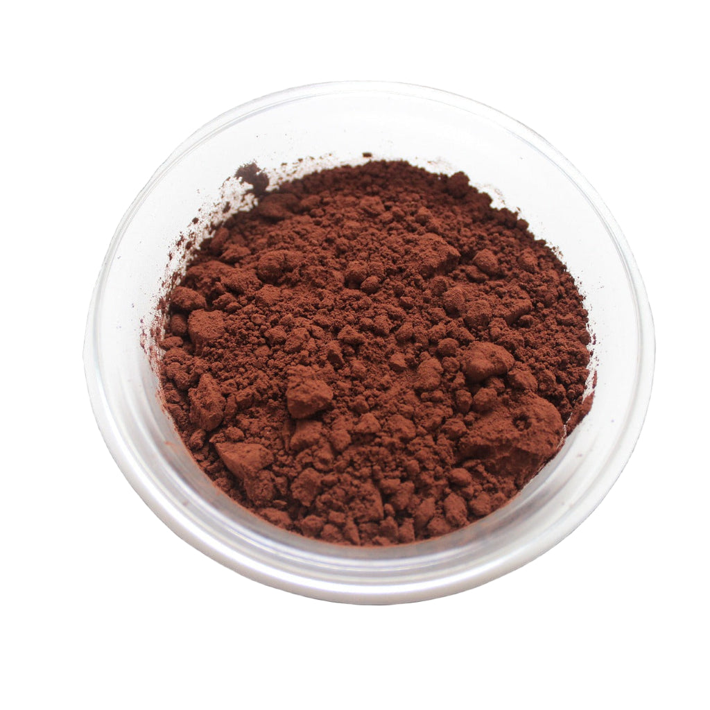 A clear bowl filled with brown cocoa powder on a white background.