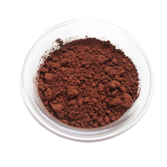 A clear bowl filled with brown cocoa powder on a white background.